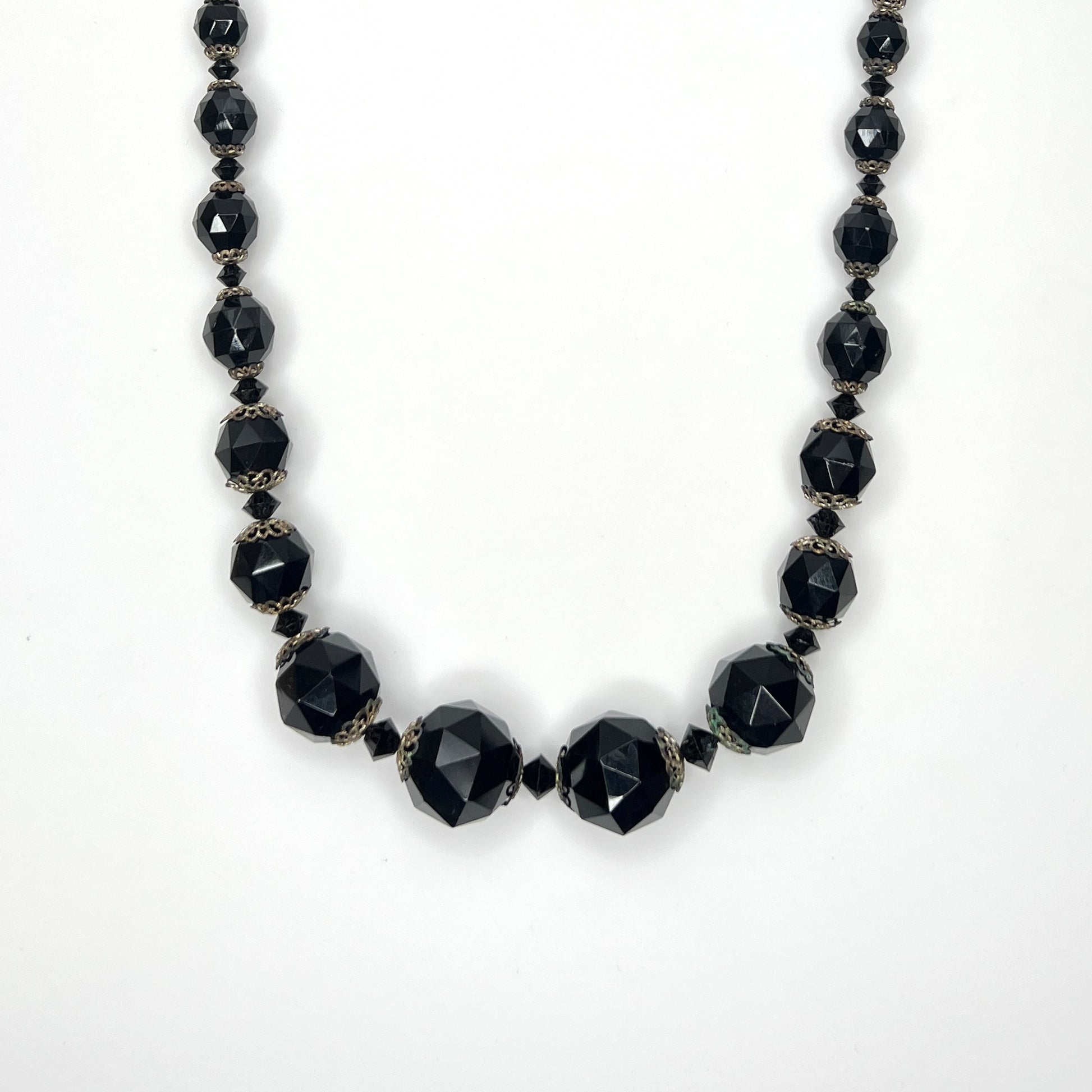 Vintage 1950s graduated jet black faceted glass bead necklace with brass filigree bead caps