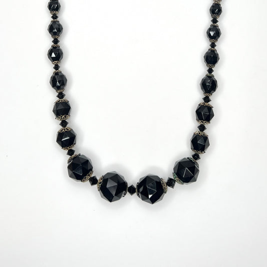 Vintage 1950s graduated jet black faceted glass bead necklace with brass filigree bead caps