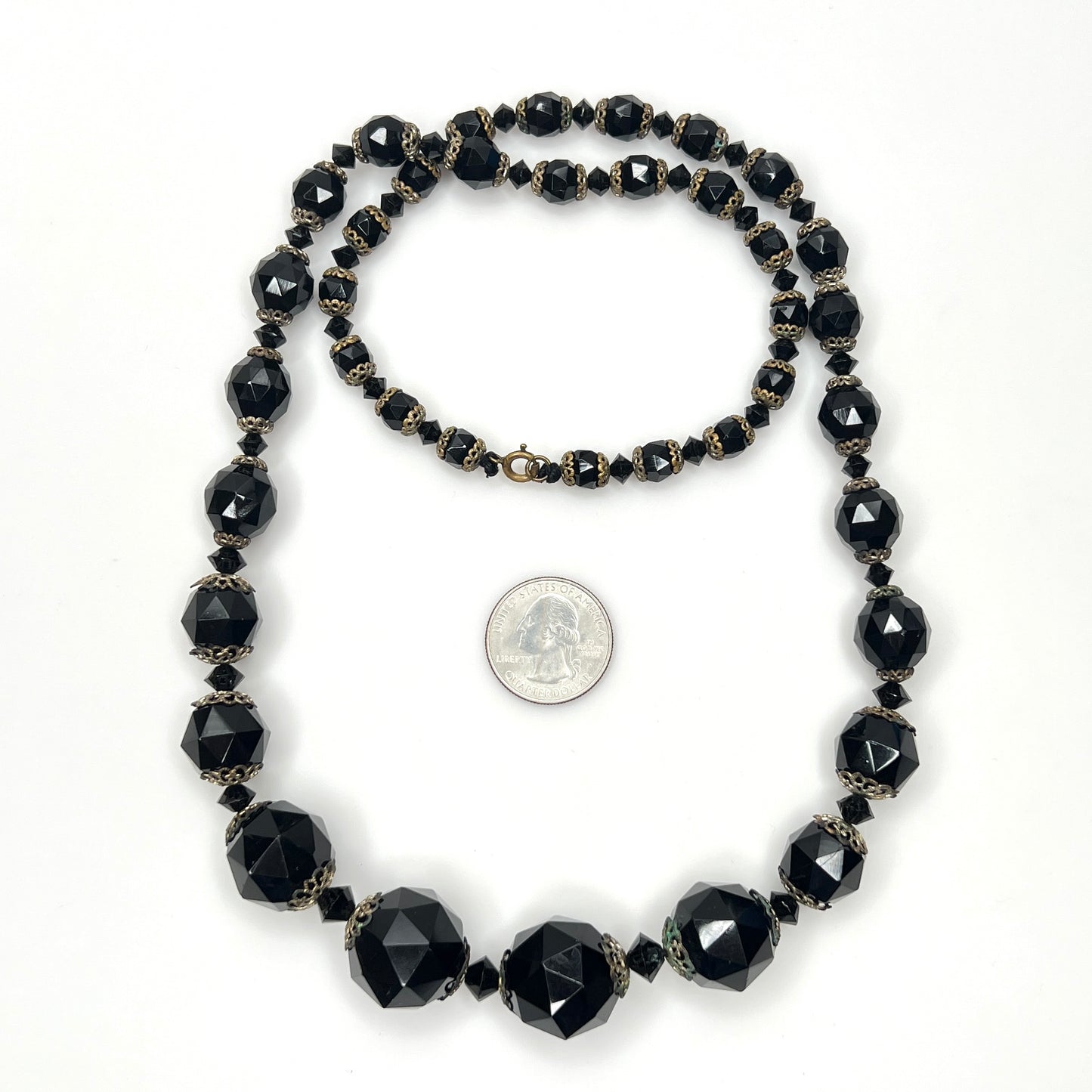 Vintage black glass necklace with graduated beads and brass-tone accents