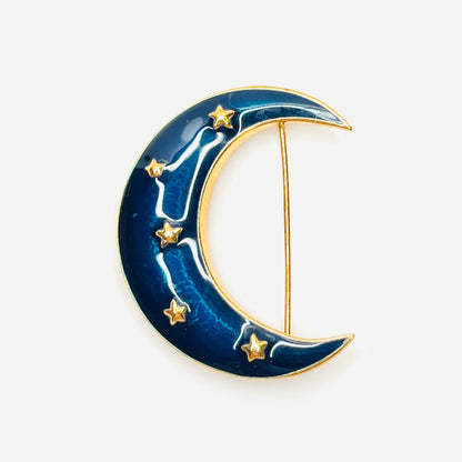 Vintage Krementz blue enamel crescent moon brooch with gold star accents.