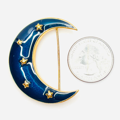 Krementz blue enamel celestial moon brooch beside a U.S. quarter for scale.