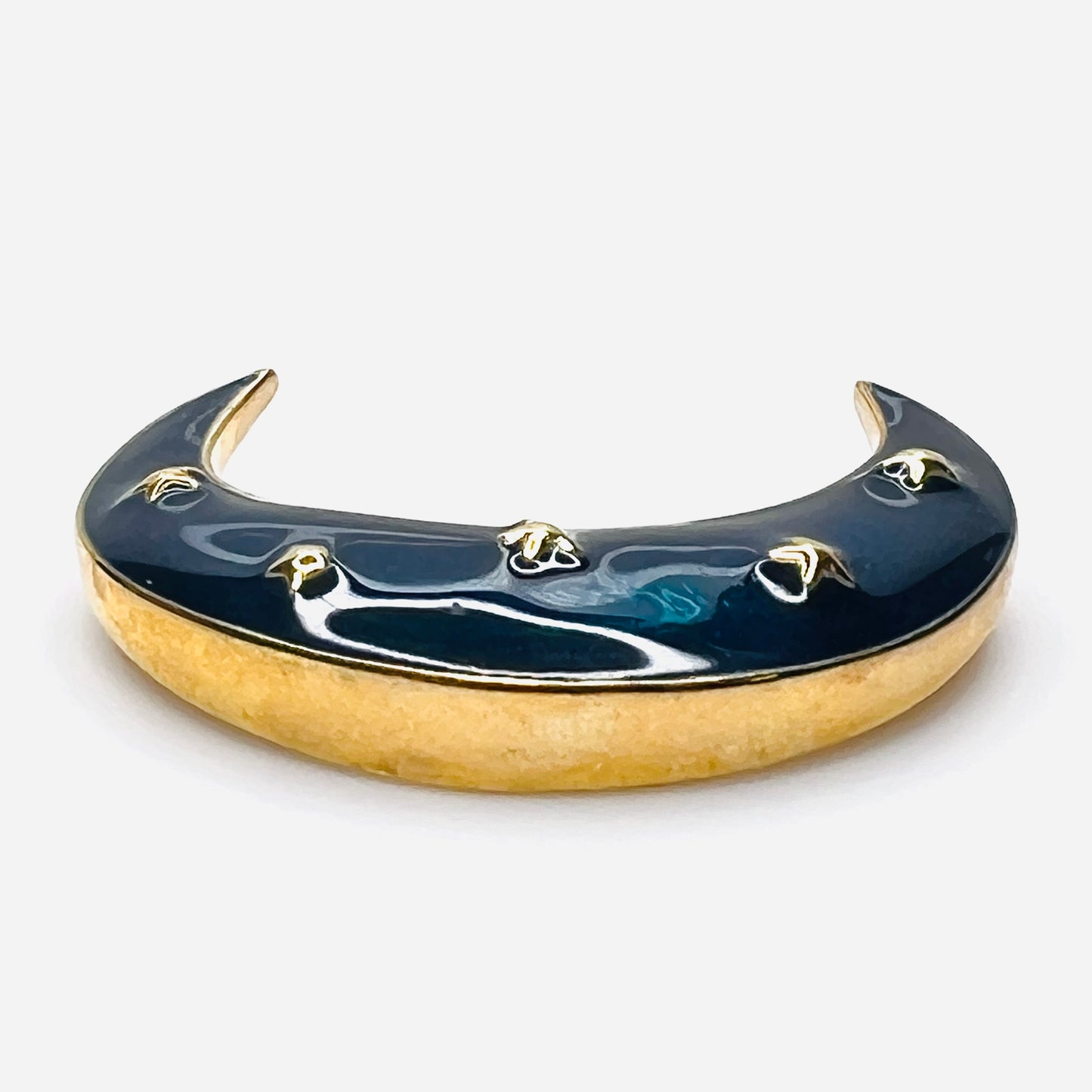 Side profile of vintage blue enamel crescent moon brooch with gold-tone finish.