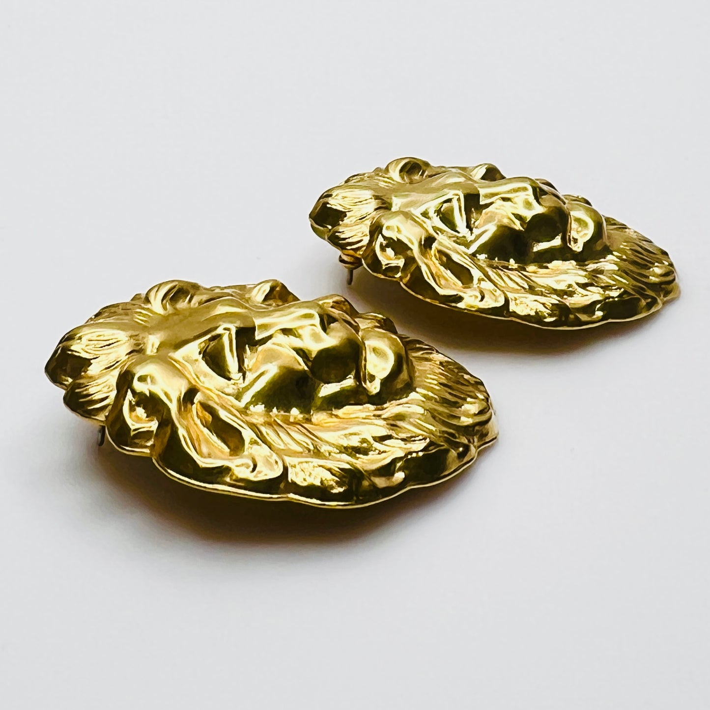 Side profile of vintage oversized lion head stud earrings