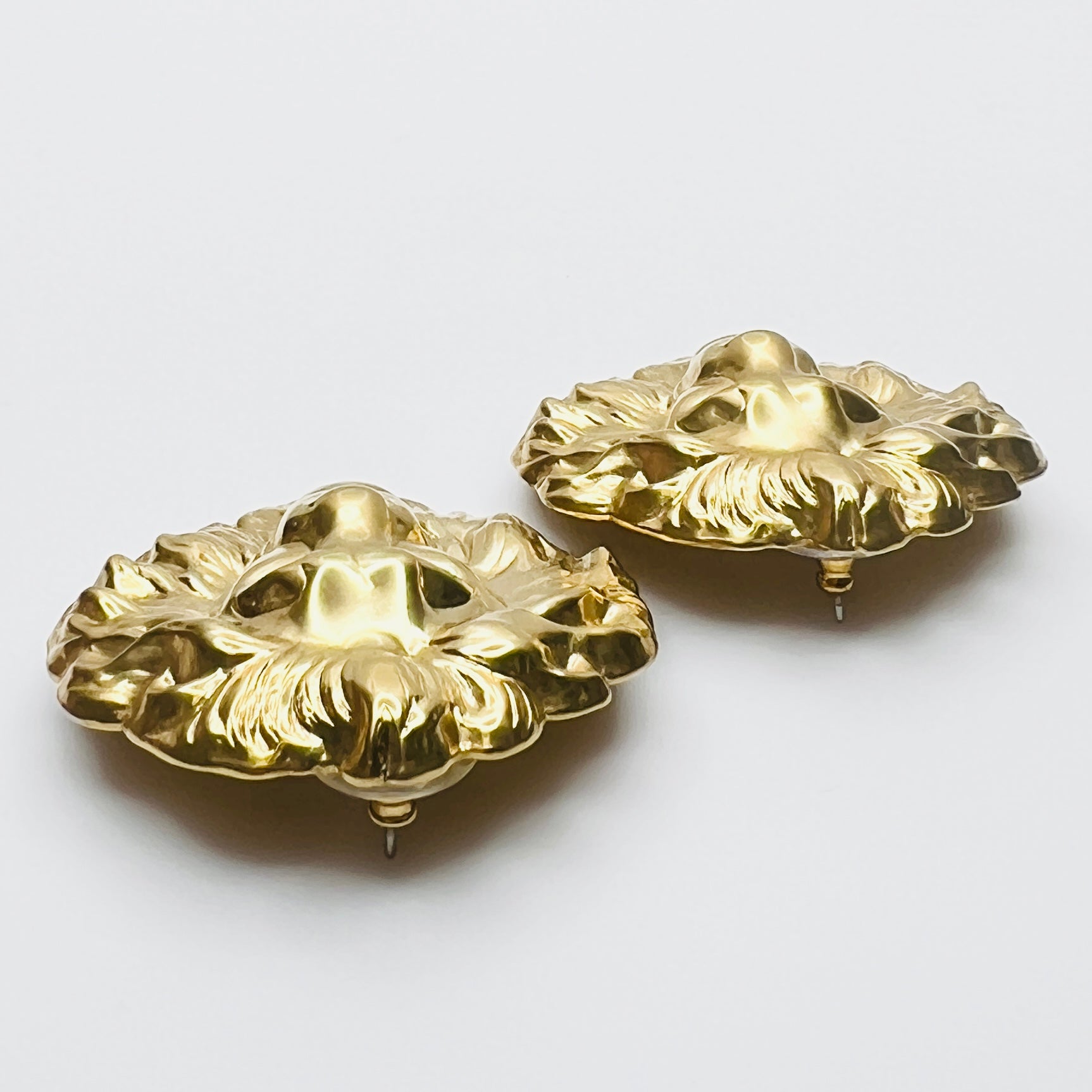 Side profile of vintage oversized lion head stud earrings
