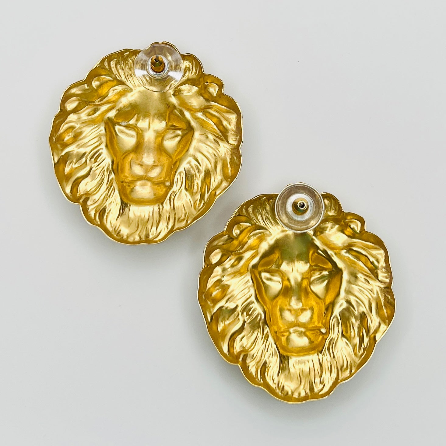 Reverse view of gold tone lion head earrings with push backs