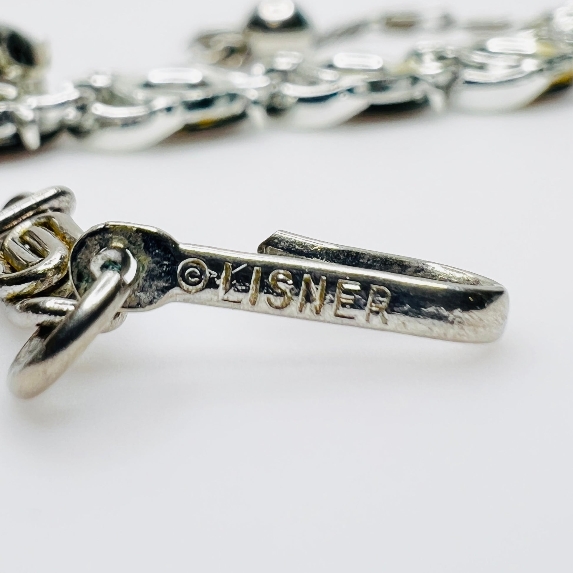 Close-up of Lisner signature stamped on original hook clasp