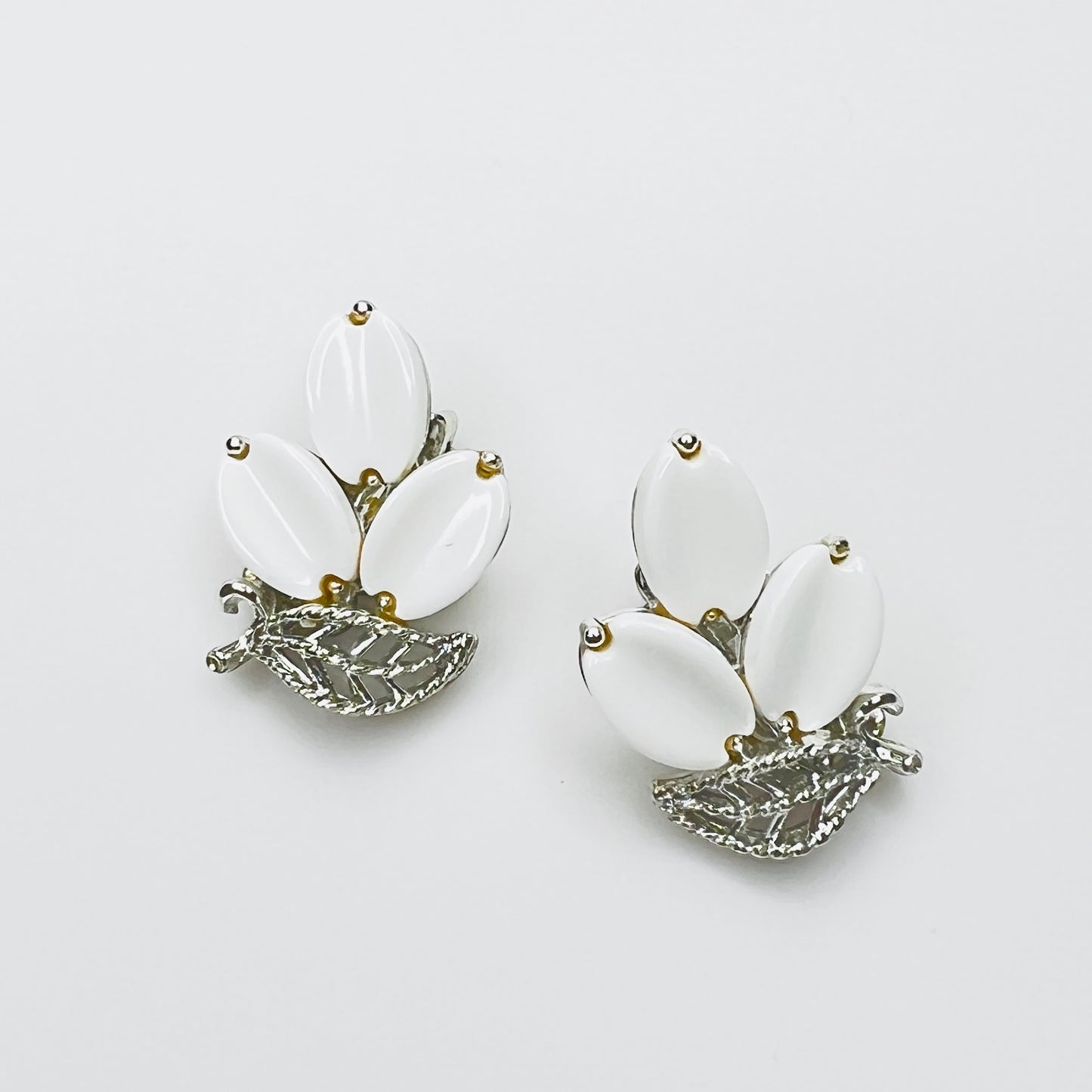 Vintage Lisner white thermoset lucite clip-on earrings with silver-tone floral leaf design