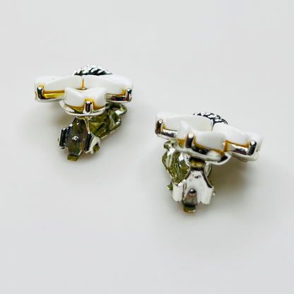 Side view of vintage Lisner white lucite clip-on earrings in silver-tone setting
