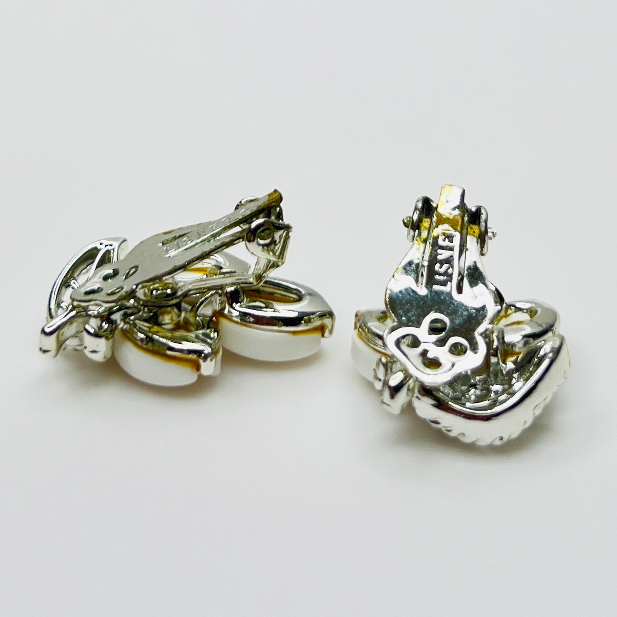 Back of signed Lisner clip-on earrings showing original clip findings