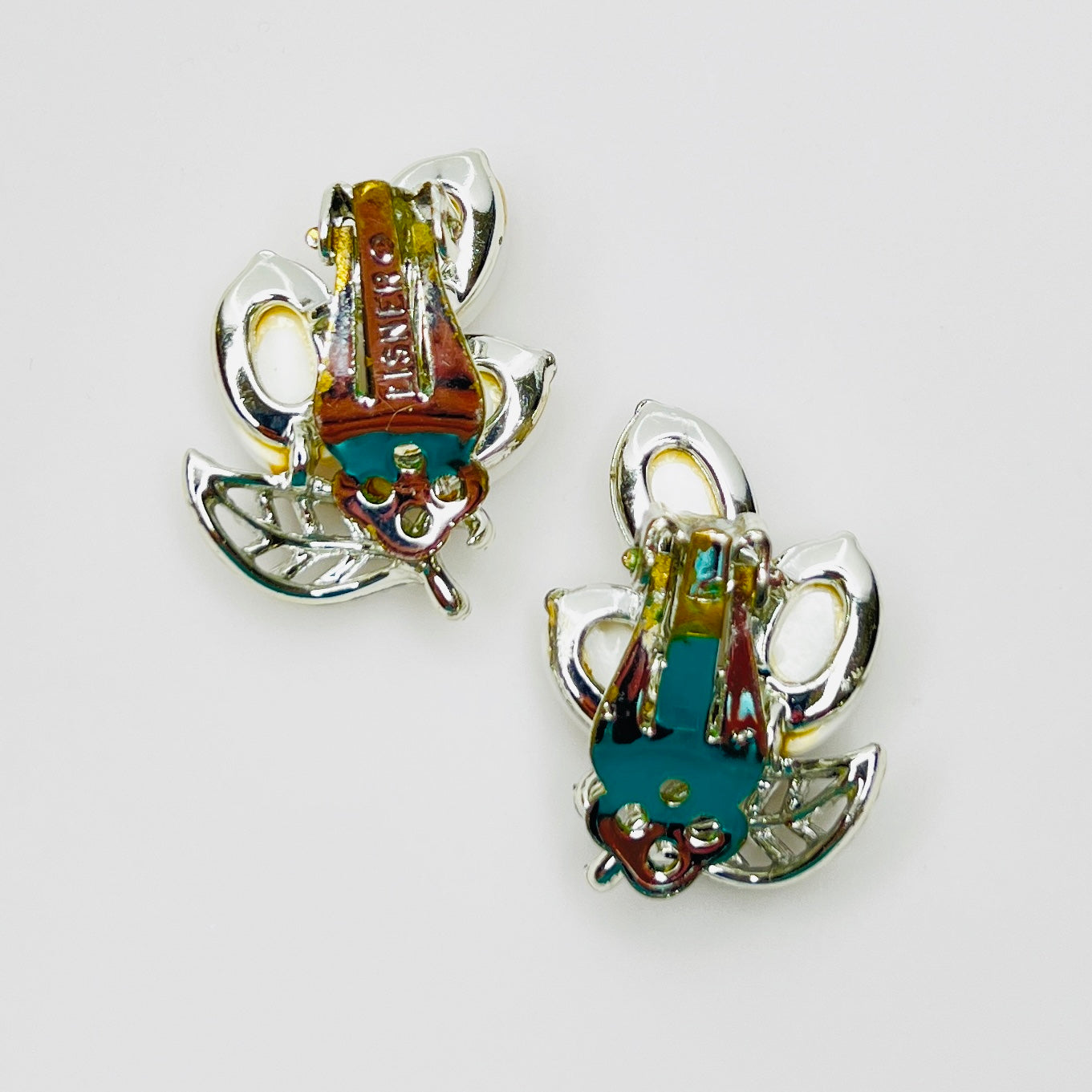 Back of signed Lisner clip-on earrings showing original clip findings