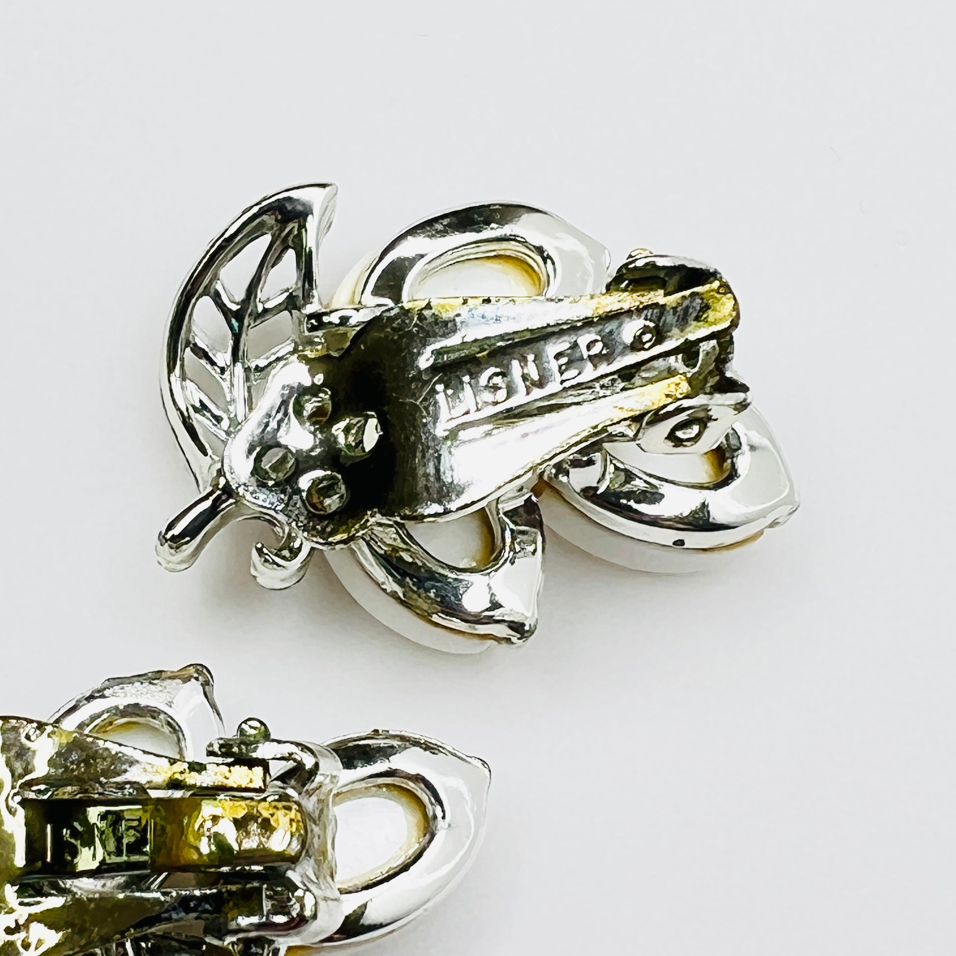 Back of signed Lisner clip-on earrings showing original clip findings