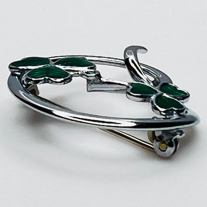Side profile of vintage Mizpah green enamel shamrock brooch showing dimensional design.