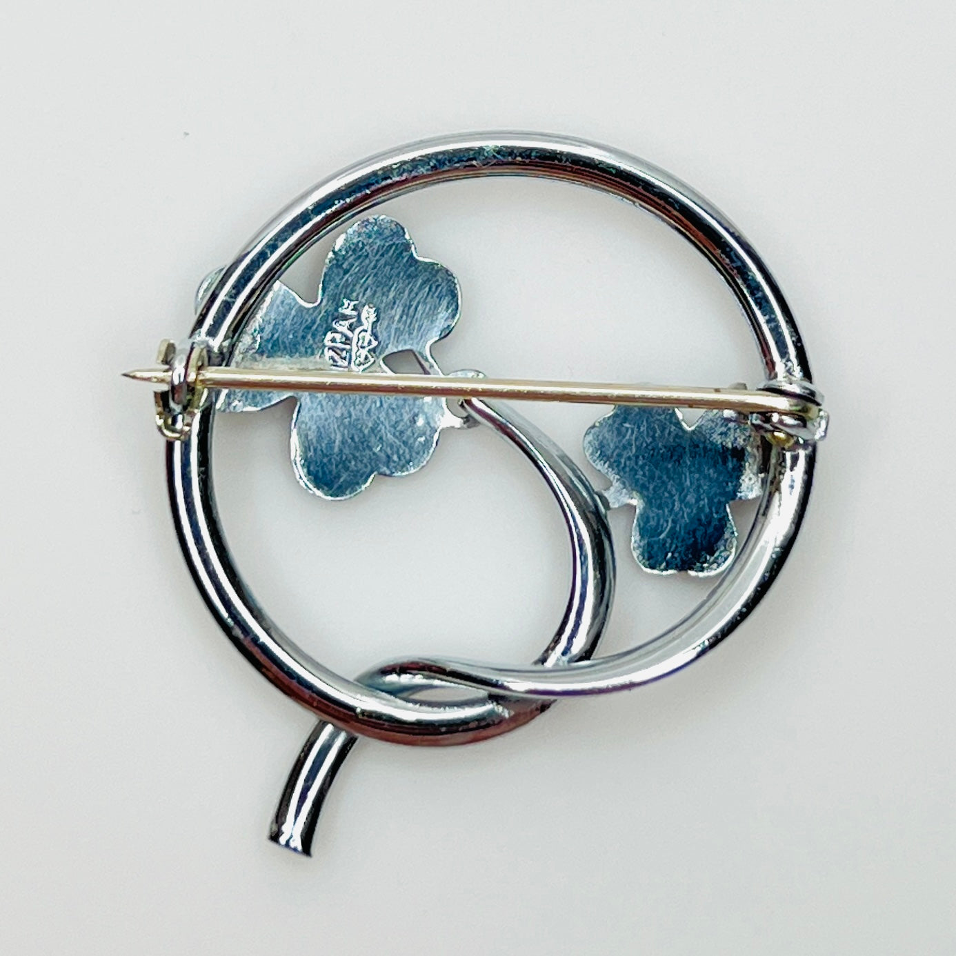 Reverse of signed Mizpah shamrock brooch with secure pin clasp and hallmark.