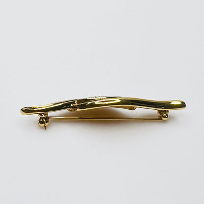 Side profile of vintage Monet rhinestone and enamel bar brooch
