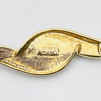 Close-up of Monet signature on reverse of vintage brooch