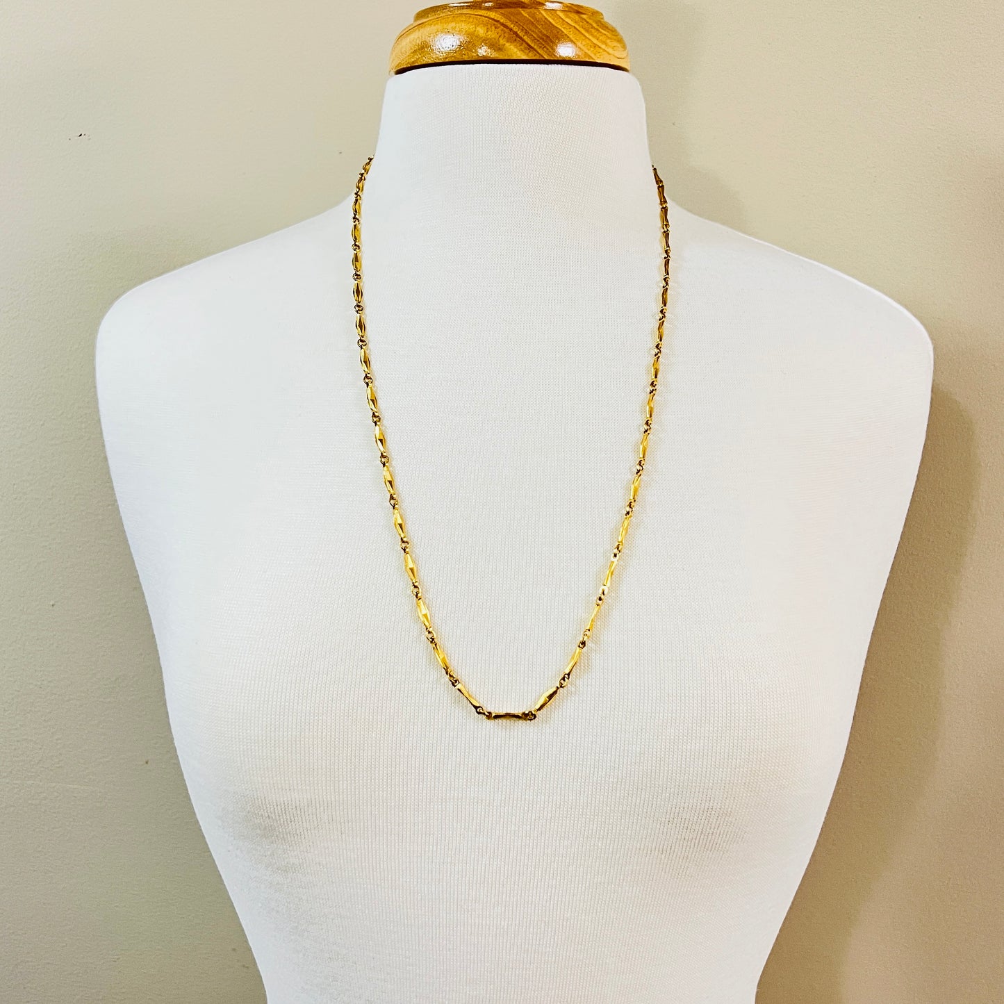 Long gold Monet chain necklace worn on mannequin