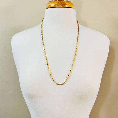 Long gold Monet chain necklace worn on mannequin