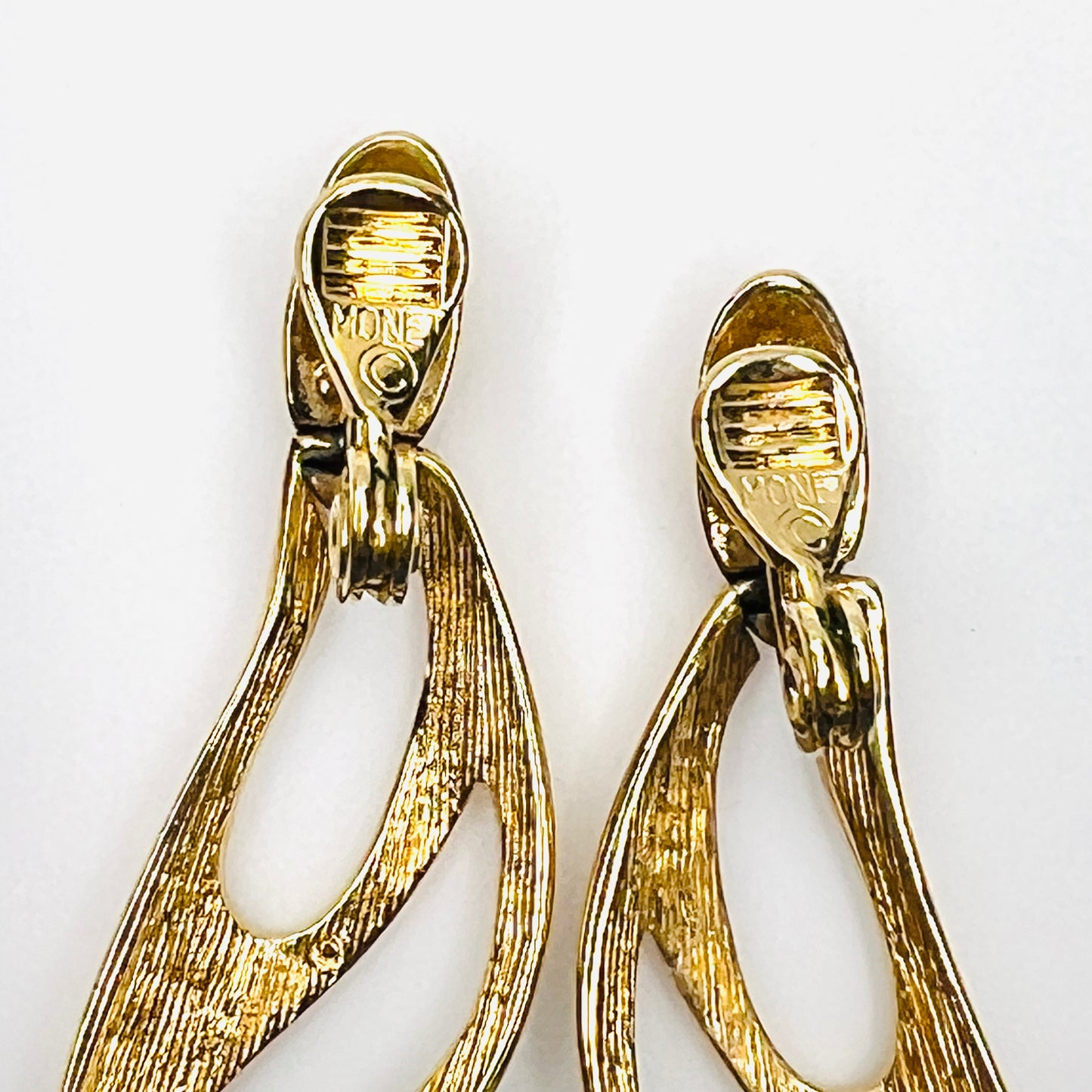 Back view of signed Monet 1980s gold-tone clip-on earrings