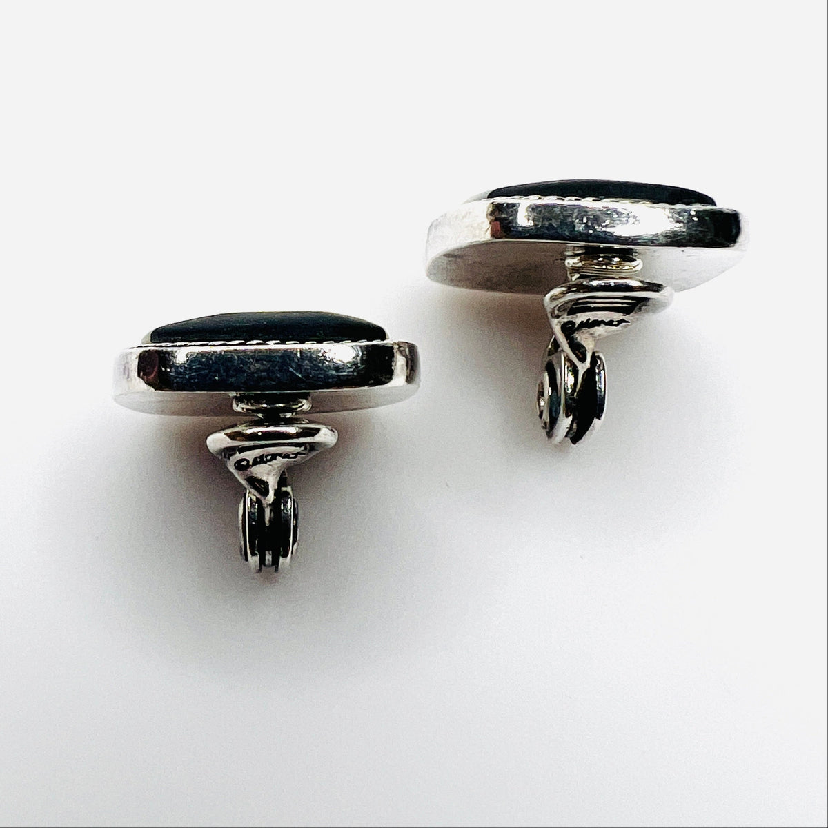 Side view of vintage Monet inlay clip-on earrings showing silver-tone clips