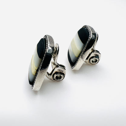Side view of vintage Monet inlay clip-on earrings showing silver-tone clips