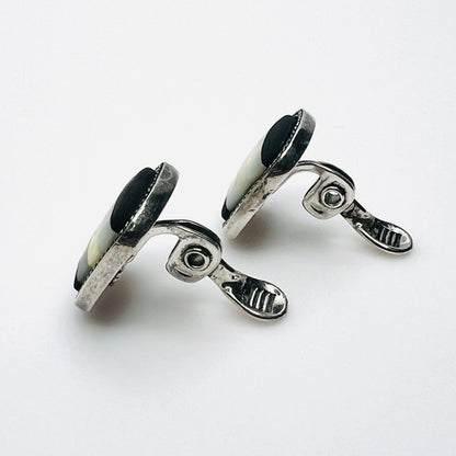 Side view of vintage Monet inlay clip-on earrings showing silver-tone clips