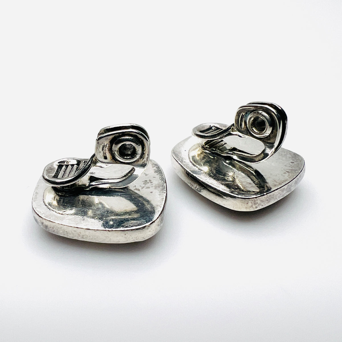 Reverse of Monet clip-on earrings showing silver-tone backs and clip fittings