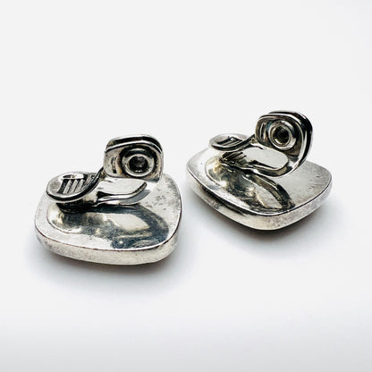 Reverse of Monet clip-on earrings showing silver-tone backs and clip fittings