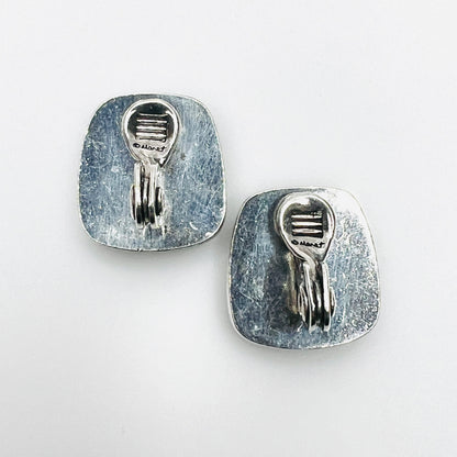 Reverse of Monet clip-on earrings showing silver-tone backs and clip fittings