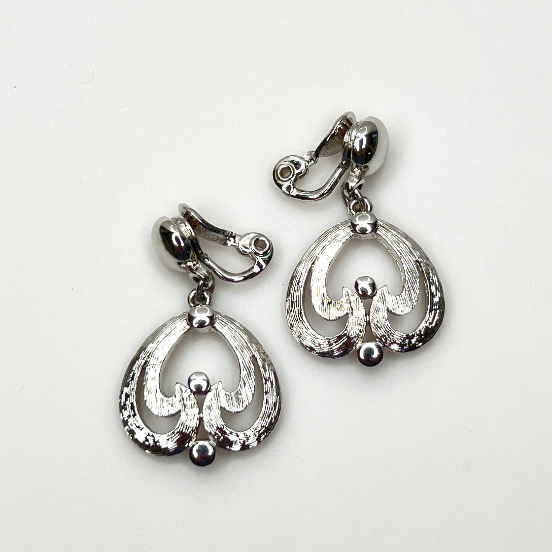 Vintage Monet silver tone abstract dangle clip-on earrings from the 1960s