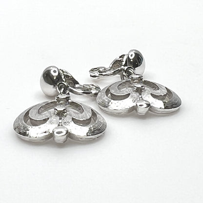 Side view of vintage Monet silver tone articulated clip-on earrings