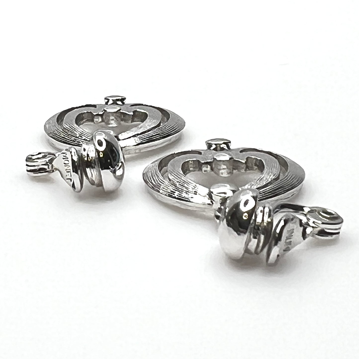 Side view of vintage Monet silver tone articulated clip-on earrings