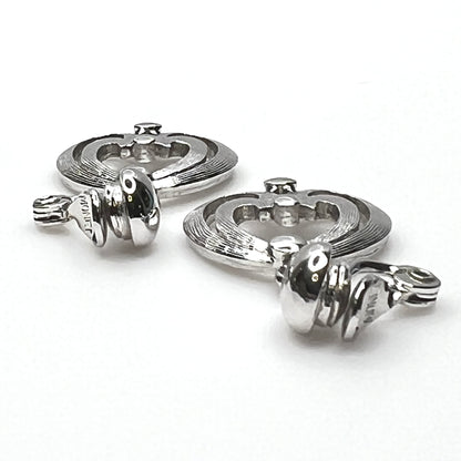Side view of vintage Monet silver tone articulated clip-on earrings