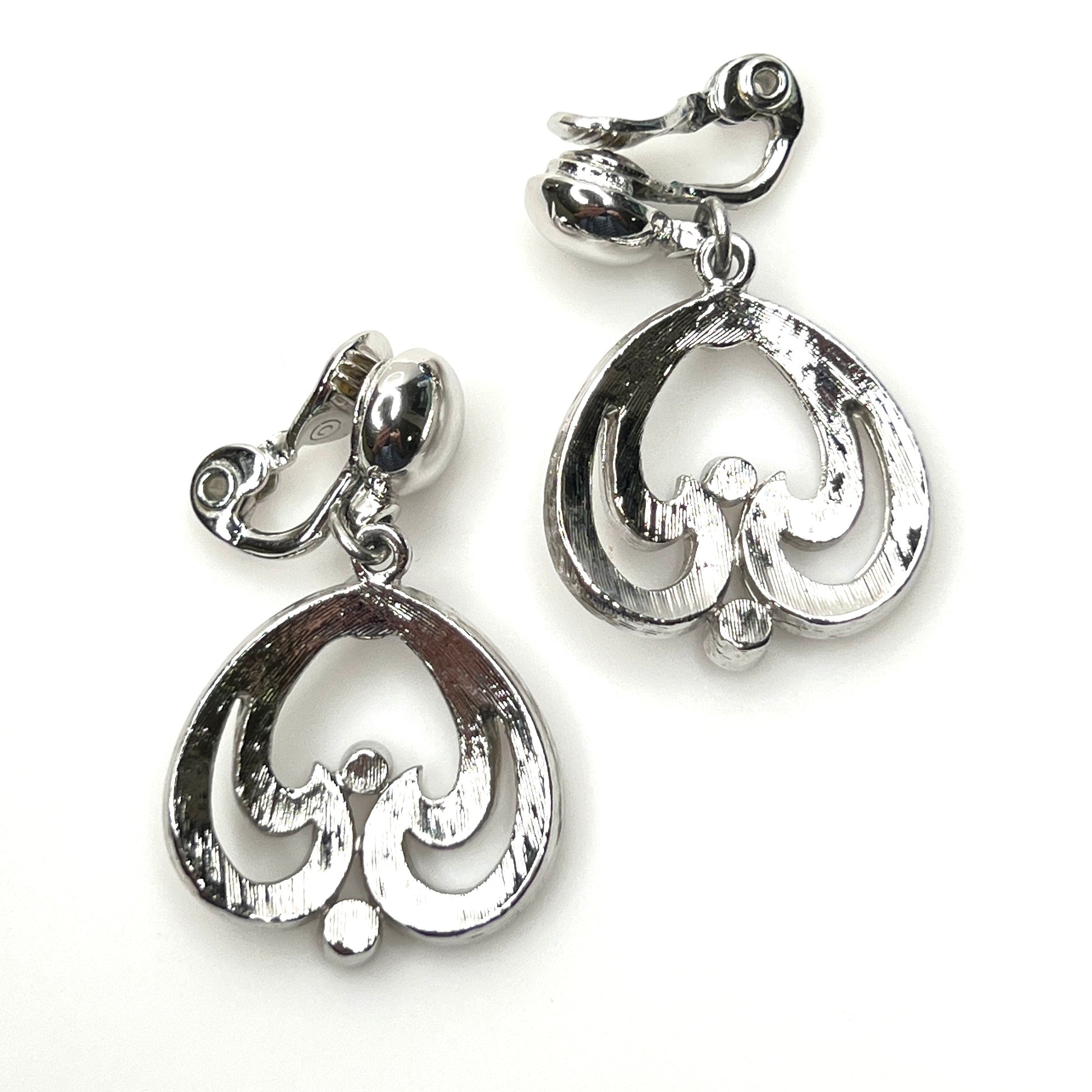 Back view of signed Monet silver tone abstract dangle earrings