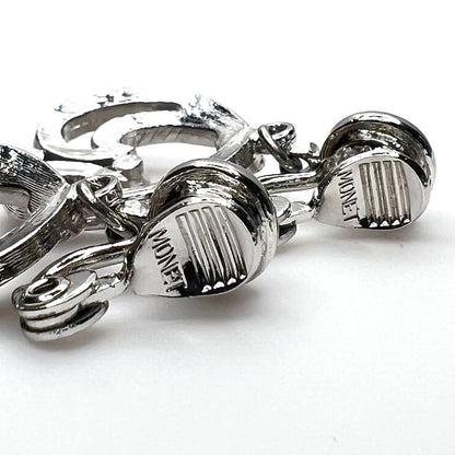 Close-up of Monet signature on vintage silver tone clip-on earrings
