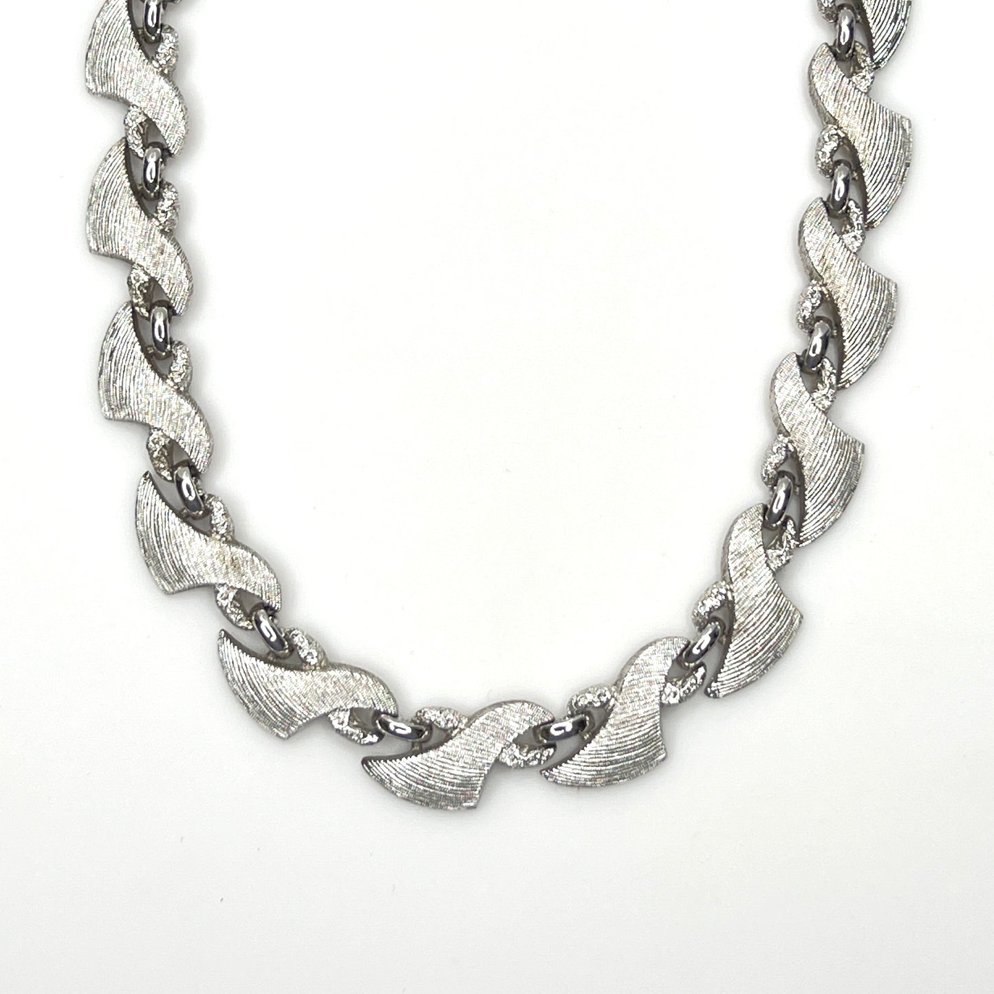 Vintage Monet silver tone textured swirl link choker necklace from the 1960s