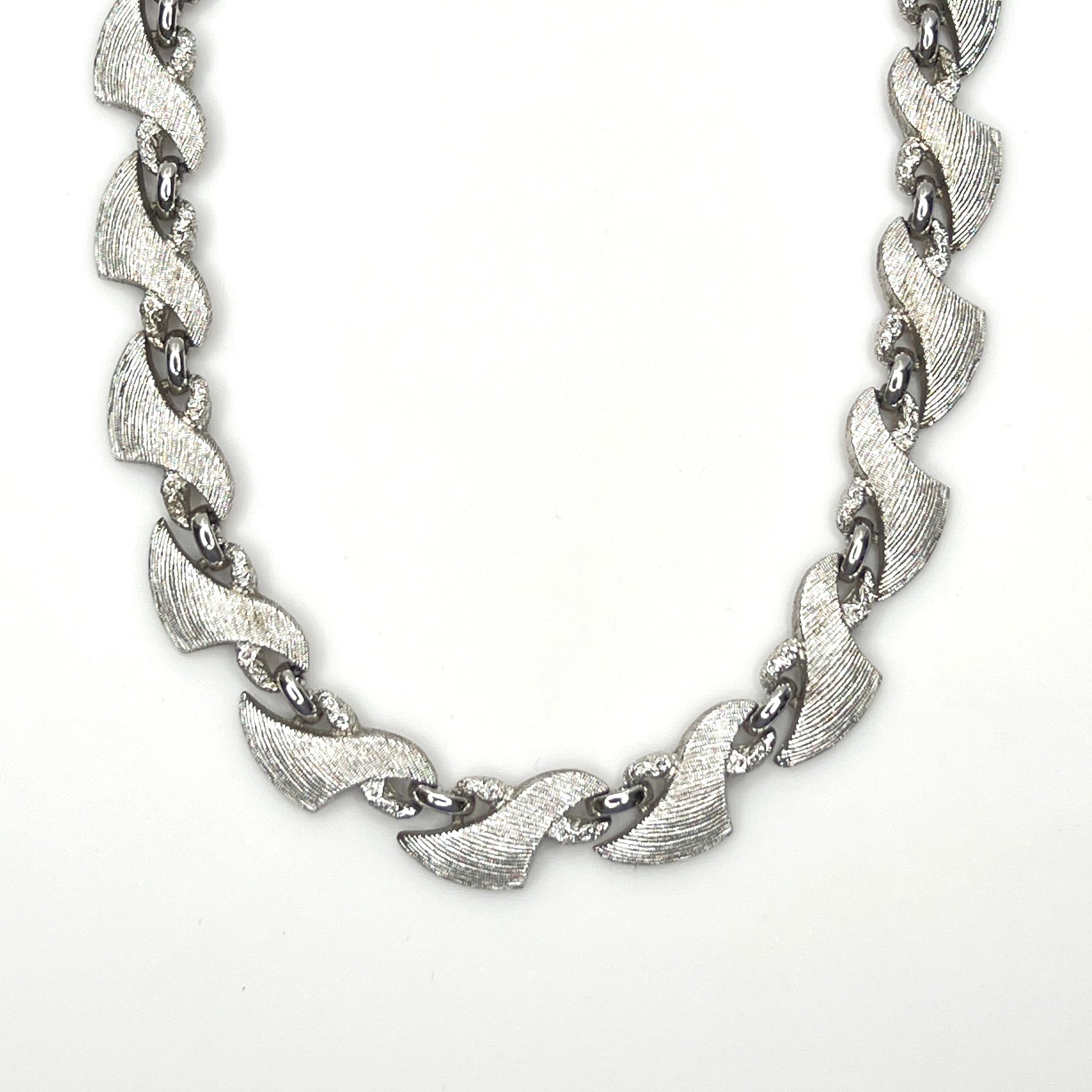 Vintage Monet silver tone textured swirl link choker necklace from the 1960s