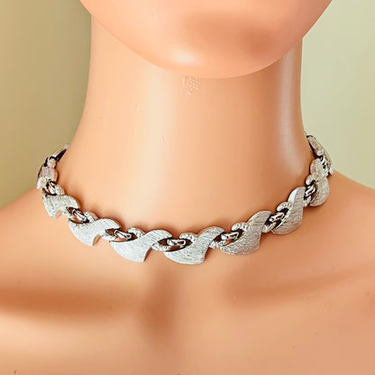 Signed Monet silver tone statement choker necklace styled on mannequin