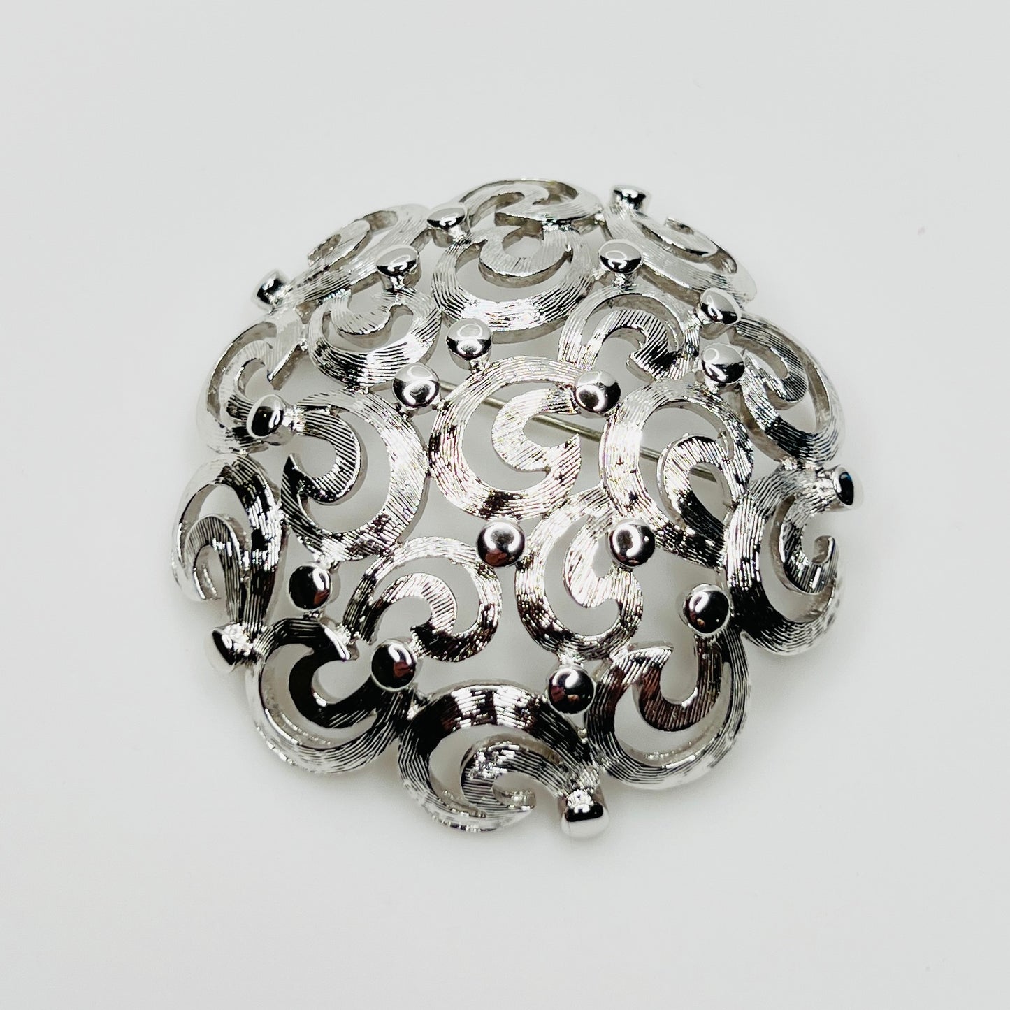 Vintage Monet silver tone swirl dome brooch filigree design
