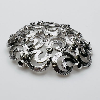 Side View of textured swirl filigree silver tone brooch