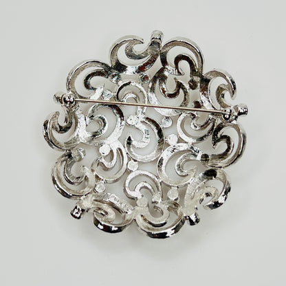 Back view of textured swirl filigree silver tone brooch