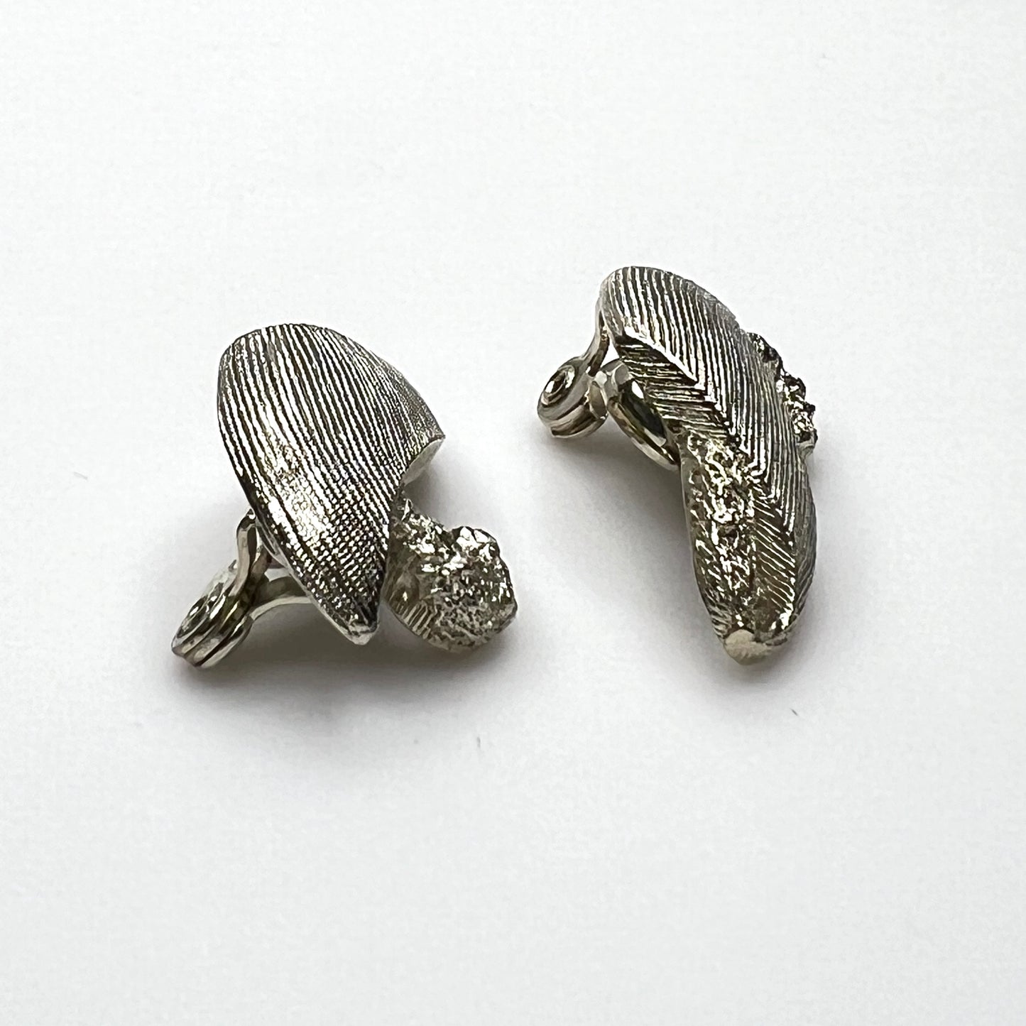 Side view of vintage Monet sculptural brushed gold tone clip-on earrings