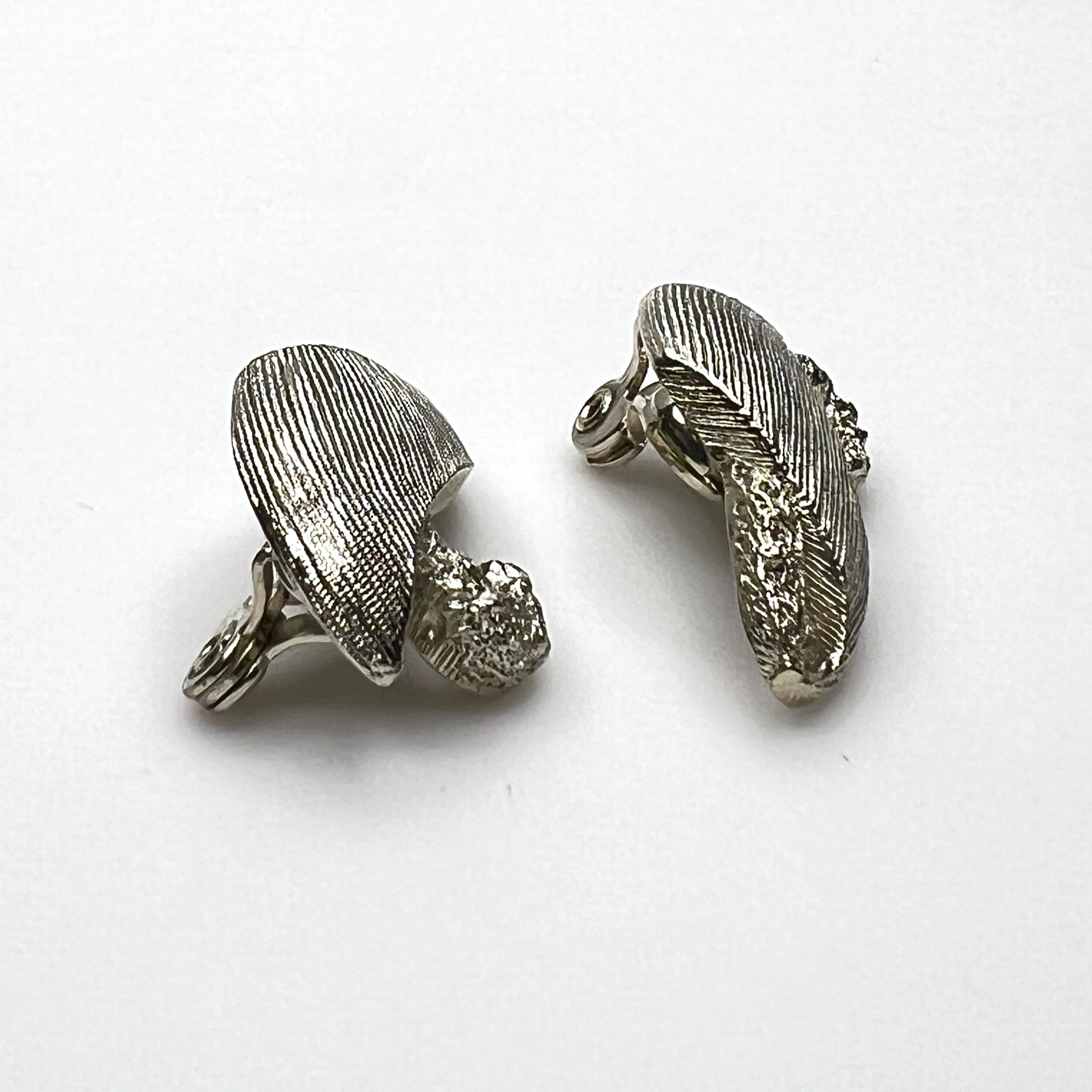 Side view of vintage Monet sculptural brushed gold tone clip-on earrings