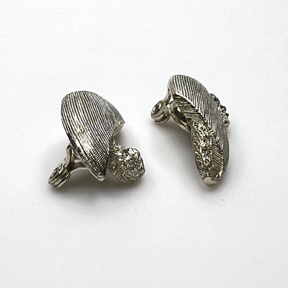 Side view of vintage Monet sculptural brushed gold tone clip-on earrings