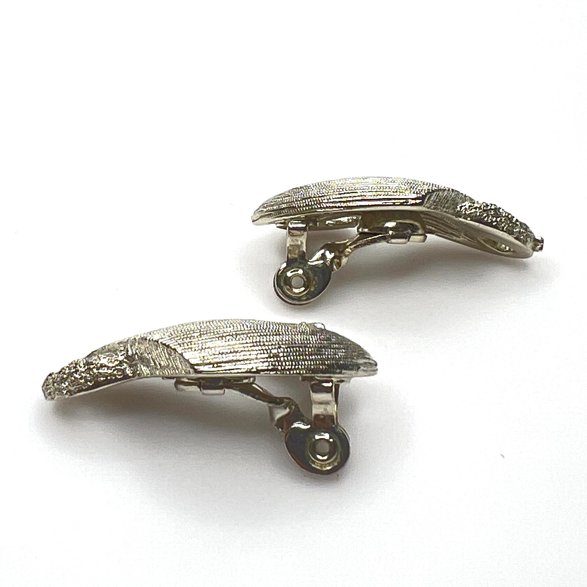 Side view of vintage Monet sculptural brushed gold tone clip-on earrings