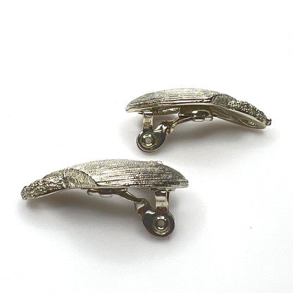 Side view of vintage Monet sculptural brushed gold tone clip-on earrings