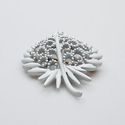 Side profile of vintage white enamel figural brooch