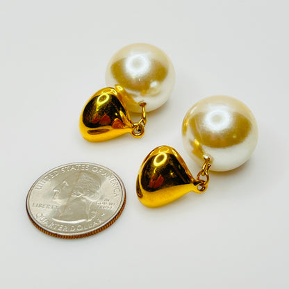 Pearl earrings next to coin for size reference