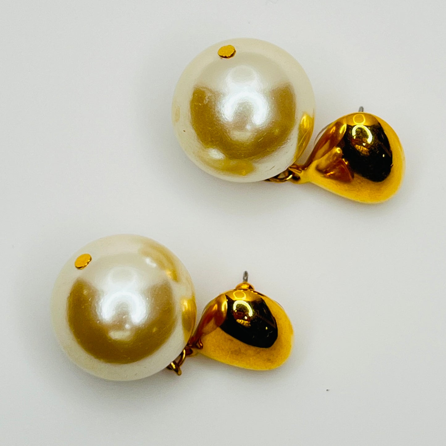 Close-up of large faux pearl and gold tone setting