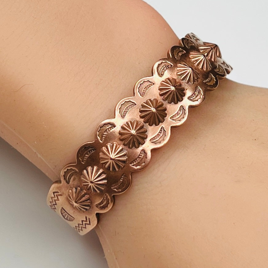 Solid copper cuff bracelet shown worn on wrist with sunburst details