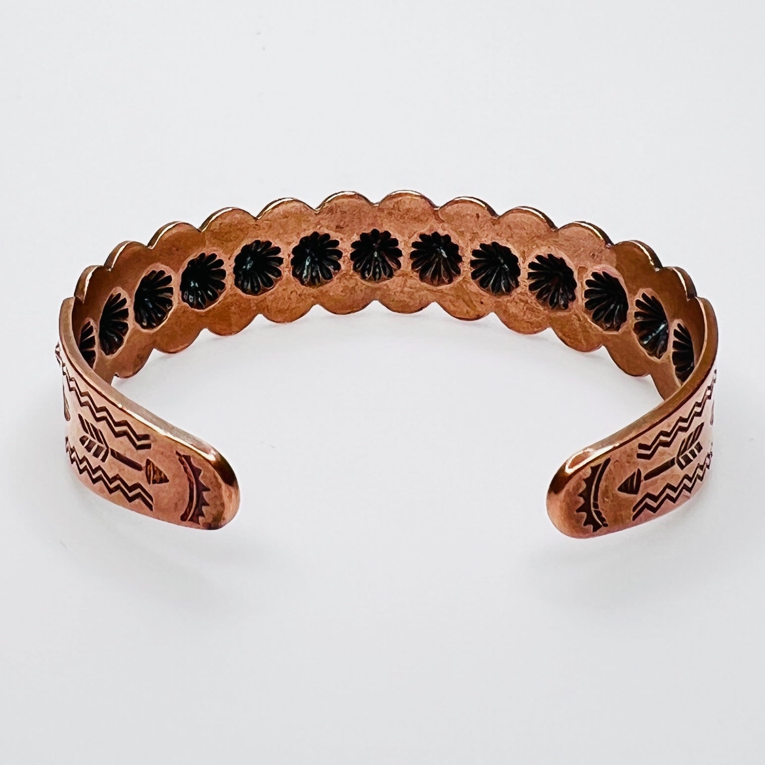 Interior view of stamped copper cuff bracelet with etched arrow motif